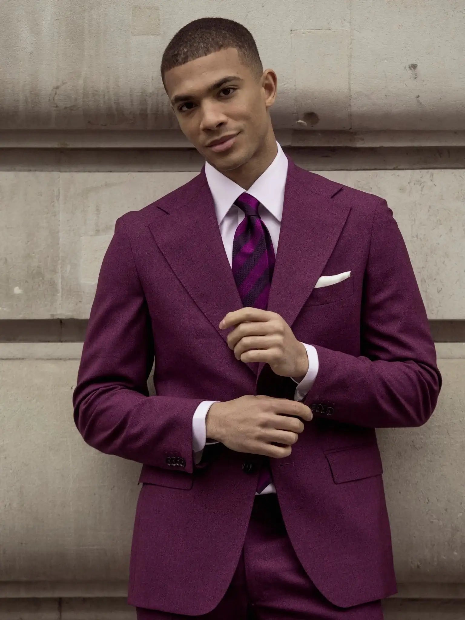 Textured purple two-piece suit on a black background, tailored fit