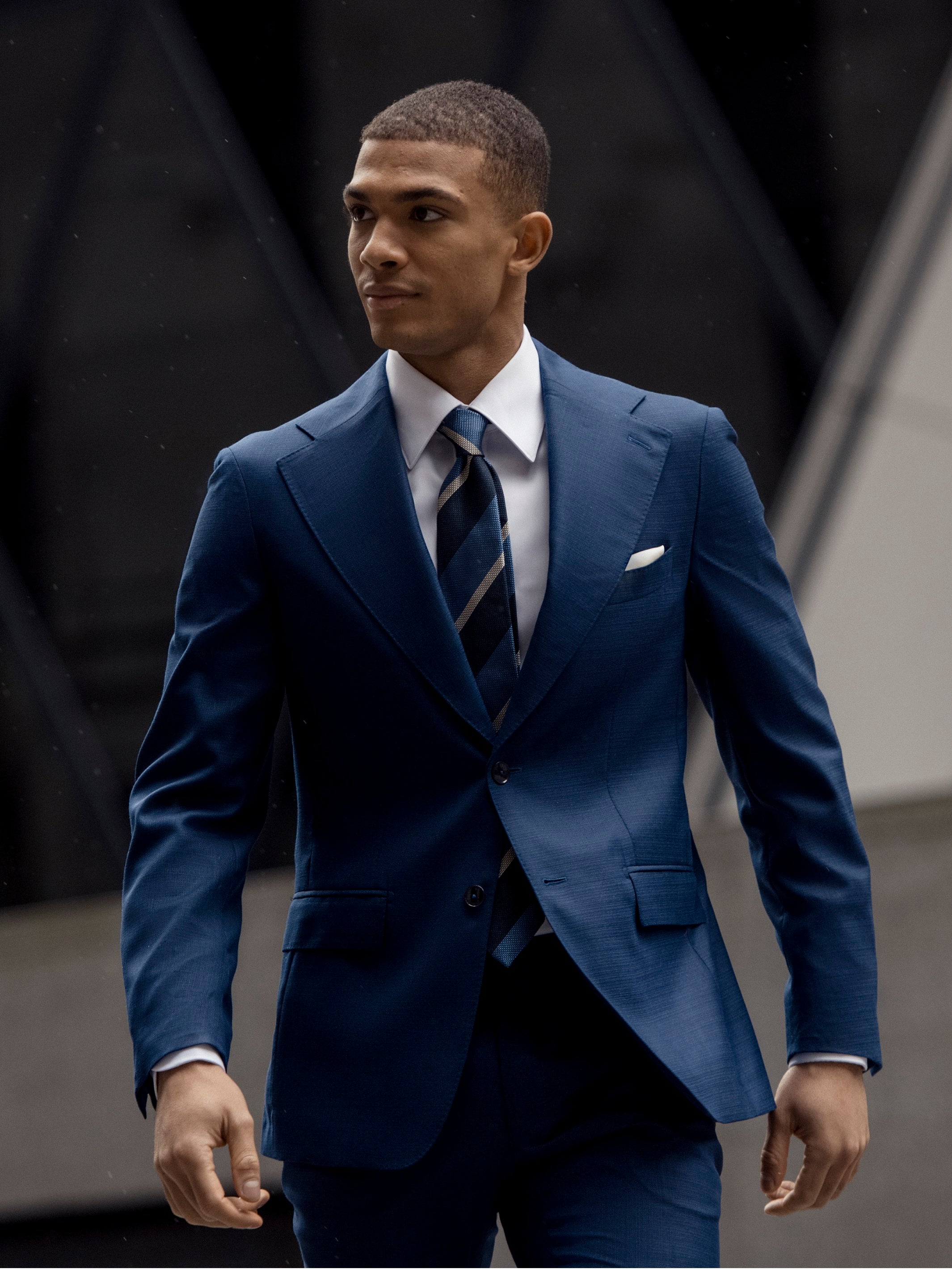 Navy blue two-piece suit with fine texture, tailored fit