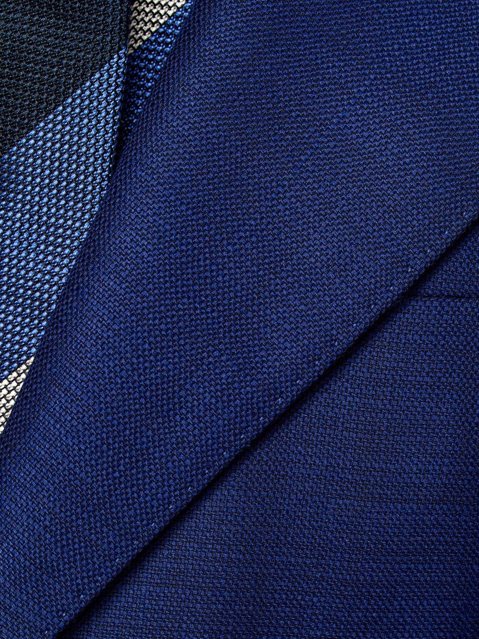 Navy blue two-piece suit with fine texture, tailored fit