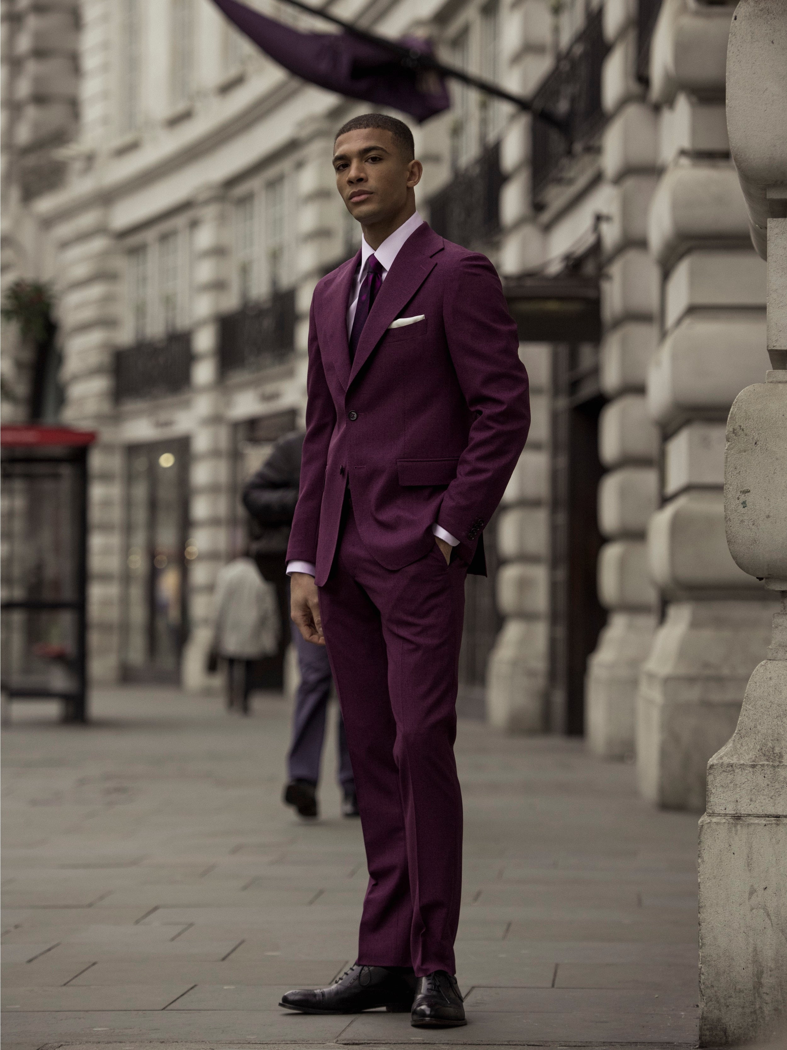 Textured purple two-piece suit on a black background, tailored fit